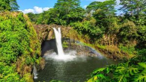 Overlooking Wailua Falls under the clear blu skies and rainbor over the waterfalls in Kauai, Hawaii, USA